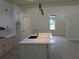 Modern kitchen featuring a large island, white cabinets, granite countertops, and pendant lighting at 136 Sequoyah Dr, Port Charlotte, FL 33954