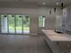 Open living space featuring sliding doors to the outside patio and a modern kitchen island at 136 Sequoyah Dr, Port Charlotte, FL 33954