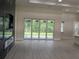 Open-concept living room featuring a fireplace and sliding glass doors to the backyard at 136 Sequoyah Dr, Port Charlotte, FL 33954