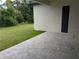 Paver patio and view of the side yard from the home's outdoor living space at 136 Sequoyah Dr, Port Charlotte, FL 33954