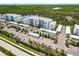 Community aerial highlights the complex, parking area, and lush landscaping at 14141 Heritage Landing Blvd # 921, Punta Gorda, FL 33955