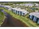 Community aerial showcases residences bordering waterway, picturesque setting, and tranquil environment at 14141 Heritage Landing Blvd # 921, Punta Gorda, FL 33955