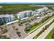 Aerial view features community buildings, expansive parking, and lush landscaping at 14141 Heritage Landing Blvd # 921, Punta Gorda, FL 33955