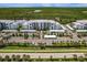 Gorgeous aerial view of condo complex with covered parking and lush tropical surroundings and water views at 14141 Heritage Landing Blvd # 921, Punta Gorda, FL 33955