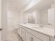 Bright bathroom with double sinks, modern fixtures, and a large vanity mirror at 14141 Heritage Landing Blvd # 921, Punta Gorda, FL 33955