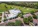 Aerial view displays the clubhouse, verdant golf course, and convenient parking at 14141 Heritage Landing Blvd # 921, Punta Gorda, FL 33955