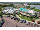 Aerial view of a luxurious community pool and clubhouse, enhanced by lush landscaping and ample parking, in a vibrant neighborhood at 14141 Heritage Landing Blvd # 921, Punta Gorda, FL 33955
