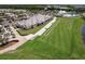 Aerial shot of a golf driving range and putting green next to a clubhouse with meticulously maintained landscaping in a premier location at 14141 Heritage Landing Blvd # 921, Punta Gorda, FL 33955