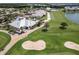 Stunning aerial view of a golf course with sand traps and immaculate greens and a stylish clubhouse in a well-maintained community at 14141 Heritage Landing Blvd # 921, Punta Gorda, FL 33955