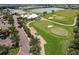 Beautiful aerial view of a golf course with lush green fairways and a clubhouse overlooking a serene lake and manicured landscaping at 14141 Heritage Landing Blvd # 921, Punta Gorda, FL 33955