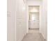 Hallway view to a light and bright bathroom with a vanity and sink at 14141 Heritage Landing Blvd # 921, Punta Gorda, FL 33955