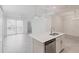 Well-lit kitchen open to living space, showcasing a center island and access to an outdoor patio at 14141 Heritage Landing Blvd # 921, Punta Gorda, FL 33955