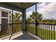 Enclosed patio with black railing provides scenic view of lush tropical landscaping and tranquil lake at 14141 Heritage Landing Blvd # 921, Punta Gorda, FL 33955
