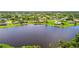 Beautiful lakefront homes featuring lush greenery and tropical landscaping for a serene, picturesque neighborhood at 170 Antilla Dr, Rotonda West, FL 33947