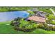 Spacious home with a private backyard overlooking a serene lake, complemented by lush landscaping and a screened pool at 170 Antilla Dr, Rotonda West, FL 33947