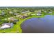 Aerial view of homes by a lake showcasing the neighborhood's layout and proximity to the water at 170 Antilla Dr, Rotonda West, FL 33947