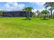 Spacious backyard featuring screened-in lanai and lush landscaping for outdoor living and privacy at 170 Antilla Dr, Rotonda West, FL 33947