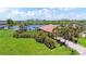 Lush tropical backyard oasis featuring mature palm trees, waterfront views, and ample space for relaxation at 170 Antilla Dr, Rotonda West, FL 33947
