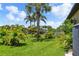 A lush backyard features well-maintained grass, tropical landscaping, and a charming gazebo at 170 Antilla Dr, Rotonda West, FL 33947