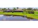 Backyard view of a waterside home with a dock, pool, and screened patio, perfect for outdoor enjoyment at 170 Antilla Dr, Rotonda West, FL 33947