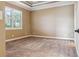 Neutral bedroom featuring a tray ceiling, plush carpeting, and plantation shutters at 170 Antilla Dr, Rotonda West, FL 33947