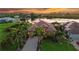 Stunning waterfront home with lush landscaping, paver driveway, and breathtaking sunset views over the lake at 170 Antilla Dr, Rotonda West, FL 33947