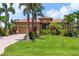 Lovely home featuring a paver driveway, lush landscaping, and a manicured lawn, enhancing its curb appeal at 170 Antilla Dr, Rotonda West, FL 33947