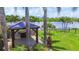 Backyard gazebo with views of the water, lush landscaping, providing a private outdoor living space at 170 Antilla Dr, Rotonda West, FL 33947