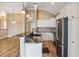 Well-appointed kitchen with stainless steel appliances, white cabinets, granite counters, and pendant lighting at 170 Antilla Dr, Rotonda West, FL 33947