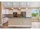 Bright kitchen with white cabinets, stainless steel appliances, an island with pendant lights, and breakfast bar at 170 Antilla Dr, Rotonda West, FL 33947