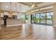 Bright kitchen features white cabinets, stainless steel appliances, island, and access to the screened patio at 170 Antilla Dr, Rotonda West, FL 33947