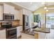 Modern kitchen featuring granite counters, stainless steel appliances, and white cabinets at 170 Antilla Dr, Rotonda West, FL 33947