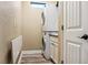 Functional laundry room featuring a stacked washer and dryer and folding table at 170 Antilla Dr, Rotonda West, FL 33947
