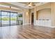 Spacious living room featuring wood floors, built-in cabinets, and access to the outdoor area at 170 Antilla Dr, Rotonda West, FL 33947