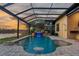 The screened pool area includes a waterfall and patio, perfect for outdoor living and entertainment at 170 Antilla Dr, Rotonda West, FL 33947