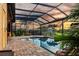 A serene screened pool area with a patio and outdoor shower creates a perfect retreat at 170 Antilla Dr, Rotonda West, FL 33947
