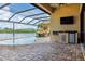Covered outdoor patio featuring outdoor kitchen, open pool and water view at 170 Antilla Dr, Rotonda West, FL 33947