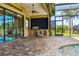 Covered outdoor patio with outdoor kitchen, open pool and water view at 170 Antilla Dr, Rotonda West, FL 33947