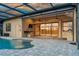 Enjoy the outdoors with a poolside patio featuring an outdoor kitchen, ceiling fans, and ample seating at 170 Antilla Dr, Rotonda West, FL 33947