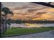 Relaxing water view from the screened lanai with the beautiful sunset reflecting on the still lake at 170 Antilla Dr, Rotonda West, FL 33947