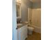 Bathroom features a shower-tub combo with white tiling and a granite vanity top at 1708 Blue Lake Cir, Punta Gorda, FL 33983
