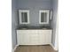 Modern bathroom with double vanity, granite countertop, and white cabinets at 1708 Blue Lake Cir, Punta Gorda, FL 33983