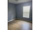 This bedroom boasts a large window, wood floor, and light blue walls at 1708 Blue Lake Cir, Punta Gorda, FL 33983