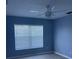 This bedroom boasts a large window, wood floor, and light blue walls at 1708 Blue Lake Cir, Punta Gorda, FL 33983