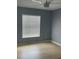 This bedroom boasts a large window, wood floor, and a ceiling fan at 1708 Blue Lake Cir, Punta Gorda, FL 33983