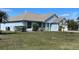 Inviting single-story home featuring a well-manicured lawn and neutral-toned roof with light-blue siding at 1708 Blue Lake Cir, Punta Gorda, FL 33983