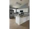 Kitchen with stainless steel appliances, granite counters, and white cabinets and a center island at 1708 Blue Lake Cir, Punta Gorda, FL 33983