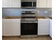 Kitchen with stainless steel appliances and white cabinets, complemented by hard surface flooring at 1708 Blue Lake Cir, Punta Gorda, FL 33983
