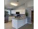Kitchen with stainless steel appliances, granite counters, and white cabinets and a center island at 1708 Blue Lake Cir, Punta Gorda, FL 33983