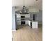 Bright kitchen featuring stainless steel appliances, white cabinetry, granite countertops, and hard surface flooring at 1708 Blue Lake Cir, Punta Gorda, FL 33983